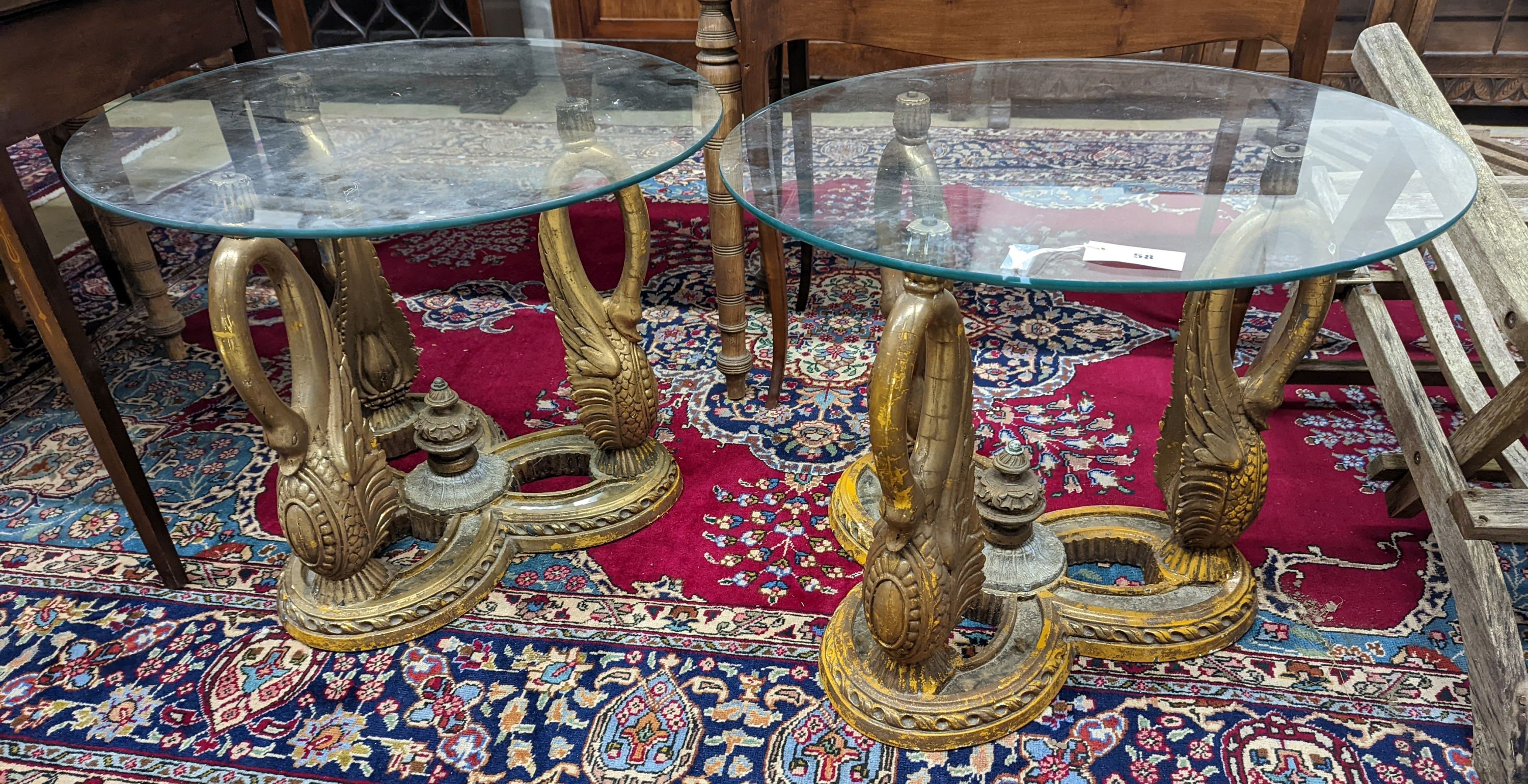 A pair of Empire style circular glass top gilt composition ‘swan’ occasional tables. D-69cm, H-55cm.